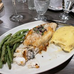 Fireside By The River - Crab stuffed haddock with two bites gone! Sides - green beans sautéed with garlic, real mashed potatoes.