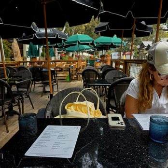 230 Forest Avenue - My friend checking out the menu at the restaurant.  Outdoor seating. - Bars Near Me - Laguna Beach, California