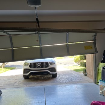 Valencia Overhead Door - Garage door hanging on by a few wheels - Garage Door Services Near Me - Santa Clarita, California Valencia Overhead Door - Garage door hanging on by a few wheels - Garage Door Services Near Me - Santa Clarita, California