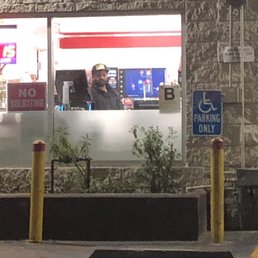 a man in a wheelchair in front of a restaurant