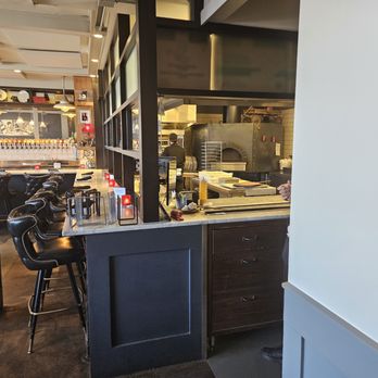 Red Wagon Pizza Company - Stools next to the kitchen.  This is a cool place to eat. - Pizza Near Me - Minneapolis, Minnesota
