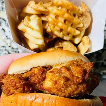 Chick-fil-A - ows a hand holding a sandwich and french fries - Fast Food Near Me - Altamonte Springs, Florida