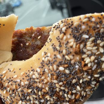 West End Bagels - a person holding a bagel with sesame seeds - Bagels Near Me - Clifton Park, New York West End Bagels - a person holding a bagel with sesame seeds - Bagels Near Me - Clifton Park, New York