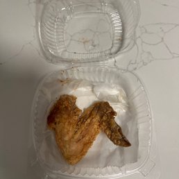 a fried chicken in a plastic container a fried chicken in a plastic container