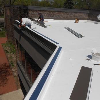 Rayco Construction - two men working on a flat roof - General Contractors Near Me - Oakdale, Minnesota