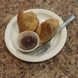 Samosas- come as a pair.   Spicy potato dumpling in dough shell and served with yogurt chatni.