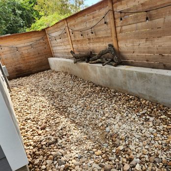 PJ Landscaping and Construcción - a backyard with gravel and wood - Landscaping Near Me PJ Landscaping and Construcción - a backyard with gravel and wood - Landscaping Near Me