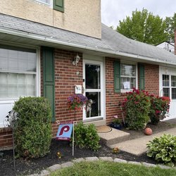 Built By Burke - Turned garage into living space, built a wall with a double window and added white Batton siding on both sides of the house