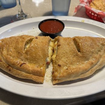 Floridino's Italian Kitchen - White calzone with pepperoni and marinara sauce. - Italian Near Me - Winter Haven, Florida Floridino's Italian Kitchen - White calzone with pepperoni and marinara sauce. - Italian Near Me - Winter Haven, Florida