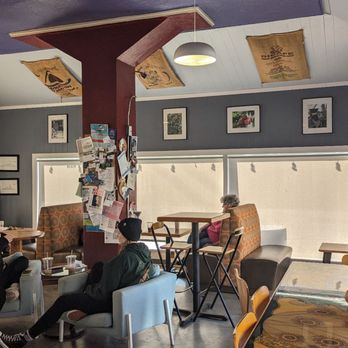 Muddy Waters Coffeehouse - a group of people sitting at tables - Coffee & Tea Near Me - Elizabeth City, North Carolina Muddy Waters Coffeehouse - a group of people sitting at tables - Coffee & Tea Near Me - Elizabeth City, North Carolina