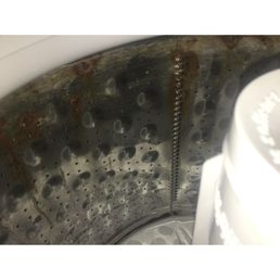 Corrosion in defective washtub that ruins clothes. Corrosion in defective washtub that ruins clothes.