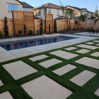 Phan's Landscaping - Turf and concrete around pool. Plants and trees. Balanced. - Landscaping Near Me Phan's Landscaping - Turf and concrete around pool. Plants and trees. Balanced. - Landscaping Near Me