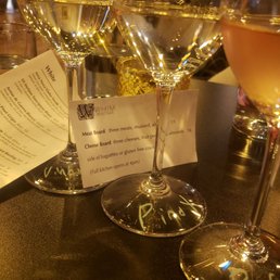three glasses of wine on a bar