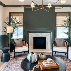 Skyline Window Coverings - Provenance® Woven Wood Shades flank each side of the fireplace with soft filtered light and natural textures.