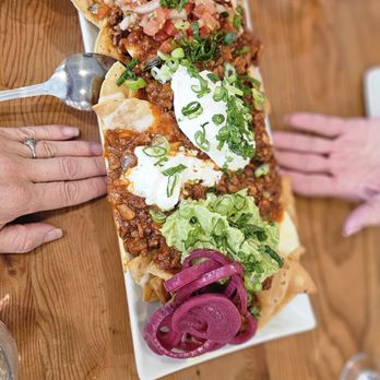 The Curious Palate - Large Nachos El Curioso - Double Pork Chili, Havarti, Ahed Cheddar, Pickled Onions, Guac, Pico, Sour Cream - New American Near Me - Santa Monica, California The Curious Palate - Large Nachos El Curioso - Double Pork Chili, Havarti, Ahed Cheddar, Pickled Onions, Guac, Pico, Sour Cream - New American Near Me - Santa Monica, California