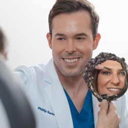 Clevens Face and Body Specialists - Merritt Island - Facial Plastic & Reconstructive Surgeon Phillip Barbee, MD consults with a cosmetic patient at Clevens Face & Body Specialists in Florida.