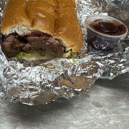 Tri tip sandwich with bbq sauce on side Tri tip sandwich with bbq sauce on side