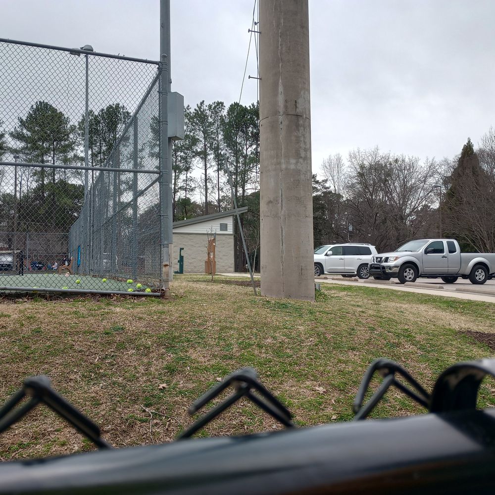 Jaycee Park - View of the edge of the tennis courts, the bathroom facilities, and the water bottle fill-up station - Community Centers Near Me - Raleigh, North Carolina Jaycee Park - View of the edge of the tennis courts, the bathroom facilities, and the water bottle fill-up station - Community Centers Near Me - Raleigh, North Carolina