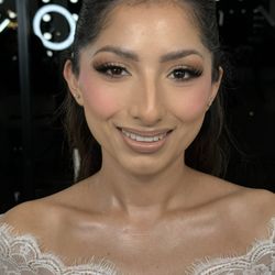 Soft bridal glam with glowing skin, sculpted brows, fluttery lashes, and a natural nude lip.