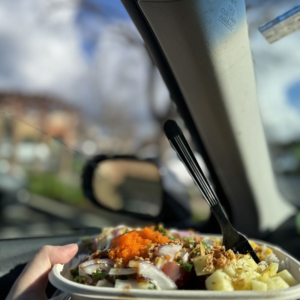 a hand holding a bowl of food