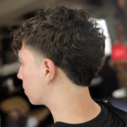 Atomic Barber Co - Modern textured crop with a clean low fade. Precision barbering designed to grow out naturally and stay sharp.