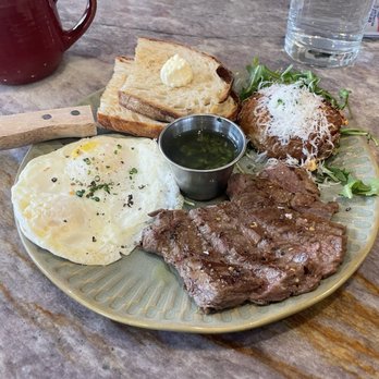 Flora - Steak. Eggs. Potato. Toast. Coffee. Water. Napkin. Sugar packet. Plate. Steak knife. - Breakfast & Brunch Near Me - San Diego, California Flora - Steak. Eggs. Potato. Toast. Coffee. Water. Napkin. Sugar packet. Plate. Steak knife. - Breakfast & Brunch Near Me - San Diego, California