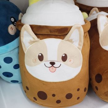 Daiso - A plush storage container designed to look like a dog, featuring a white and tan face with a pink tongue, brown body with dark spots, and a soft, rounded shape. - Discount Store Near Me - Rancho Cucamonga, California