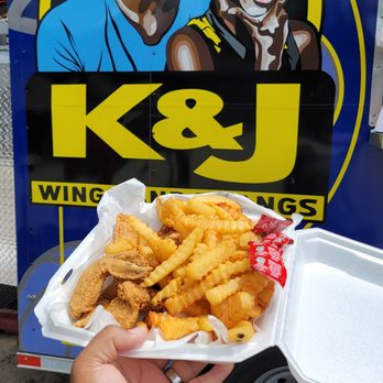 K & J Wings and Thangs - hand holding a tray of fried chicken wings - Chicken Wings Near Me - Jacksonville, Florida K & J Wings and Thangs - hand holding a tray of fried chicken wings - Chicken Wings Near Me - Jacksonville, Florida