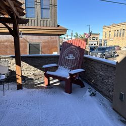 Giant Adirondack chair dusted in snow.