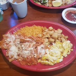 Chilaquiles Rojos with potatoes rice and scrambled eggs. My mom got some dish with tacos and skewered shrimp Chilaquiles Rojos with potatoes rice and scrambled eggs. My mom got some dish with tacos and skewered shrimp