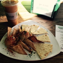 Greens and Proteins - Hummus and pita plate and carrot juice to drink.