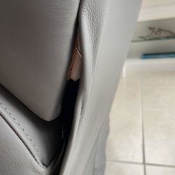 Hudson's Furniture - Seam not seen to bottom of back. Metal piece sticking out of seam.