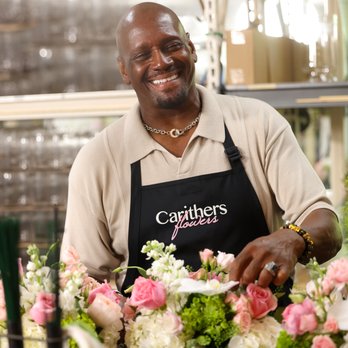 Carithers Flowers - Our designer adding the finishing touches to a customer's party centerpieces - Florists Near Me - Marietta, Georgia Carithers Flowers - Our designer adding the finishing touches to a customer's party centerpieces - Florists Near Me - Marietta, Georgia