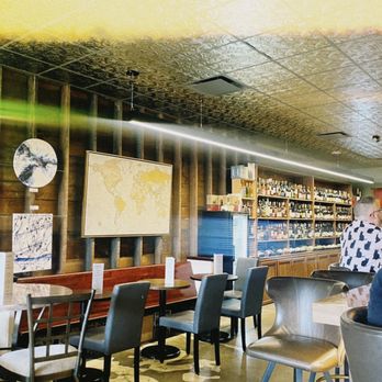 Eleven Eleven - a man sitting at a table in a restaurant - Wine Bars Near Me - Omaha, Nebraska