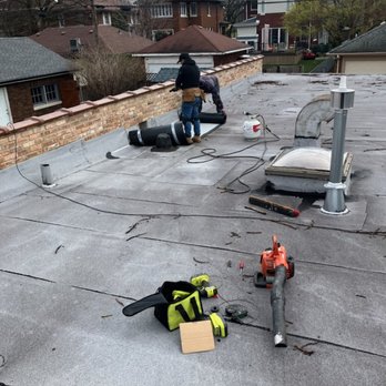 Nicholas Roofing & Tuckpointing - Applying the modified bitumen patch by the scupper box. - Roofing Near Me Nicholas Roofing & Tuckpointing - Applying the modified bitumen patch by the scupper box. - Roofing Near Me