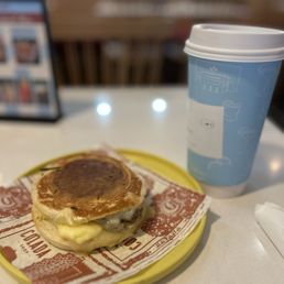 Pork breakfast sandwich and a cafe con leche. Pork breakfast sandwich and a cafe con leche.