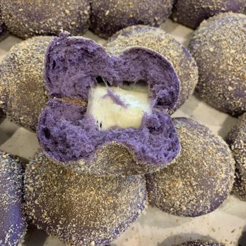 Claire’s Kitchen - a purple doughnut with a bite taken out of it - Bakeries Near Me - Atlanta, Georgia