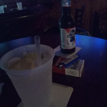 The Tavrne - a drink and a book on a table - Dive Bars Near Me - Myrtle Beach, South Carolina
