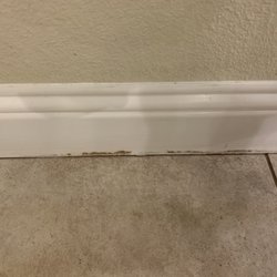 DFW Appliance Repair - Water damaged baseboards. Paint pulling away as boards swell.