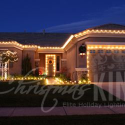 The Christmas Kings - One story home with path lighting and tree wrapped with minis.