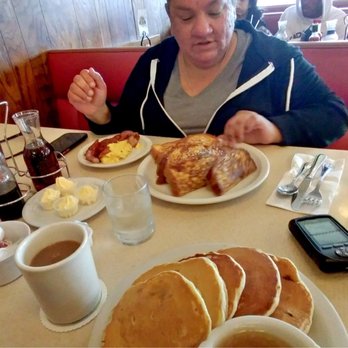 The Pancake Chef - Banana Pancakes (closer to the camera), and my wife eating French toast. Lots of food. - American Near Me - SeaTac, Washington