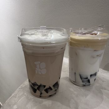 Torotea - Left: UVA milk tea topped with Himalayan sea salt cold foam brown sugar tapiochi. Right: crème brûlée milk latte with brown sugar tapiochi - Coffee & Tea Near Me - San Marino, California Torotea - Left: UVA milk tea topped with Himalayan sea salt cold foam brown sugar tapiochi. Right: crème brûlée milk latte with brown sugar tapiochi - Coffee & Tea Near Me - San Marino, California