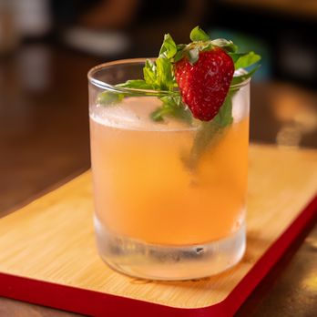 Pitanga - a drink in a glass on a wooden tray - Comfort Food Near Me - Brooklyn, New York