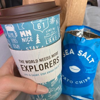 Caribou Coffee - a person holding a cup of coffee - Coffee & Tea Near Me - Sioux Falls, South Dakota