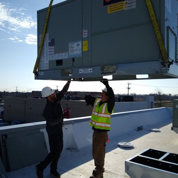 Com24 Heating And Air Conditioning - Com24 Technicians working on a commercial RTU - Electricians Near Me - Cary, Illinois Com24 Heating And Air Conditioning - Com24 Technicians working on a commercial RTU - Electricians Near Me - Cary, Illinois