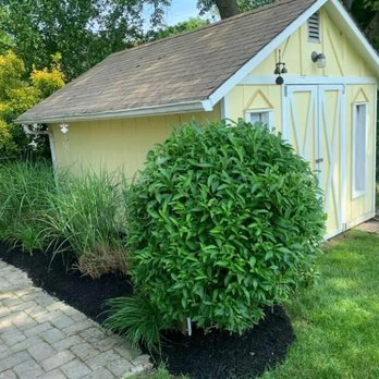 Kohle's Landscaping Services - a yellow shed with a white trim - Landscaping Near Me