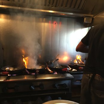 Thai Tom - View from the center counter. The chef (Tom?) doing is thing. - Thai Near Me - Seattle, Washington Thai Tom - View from the center counter. The chef (Tom?) doing is thing. - Thai Near Me - Seattle, Washington
