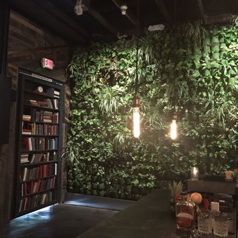 Pigtails Desert Ridge - Bar view of the bookshelf door and gorgeous wall of plants - Cocktail Bars Near Me - Phoenix, Arizona Pigtails Desert Ridge - Bar view of the bookshelf door and gorgeous wall of plants - Cocktail Bars Near Me - Phoenix, Arizona