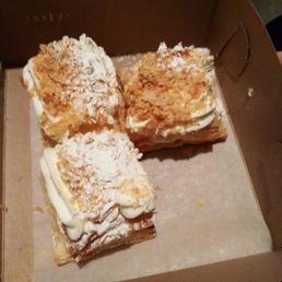 four pieces of pastry in a box