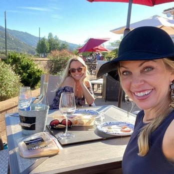Sunrise Vineyards - Beautiful guest enjoying the spectacular views with a bottle of Viognier and charcuterie board (Brie, salami, crackers and rosemary) - Wineries Near Me - Ramona, California